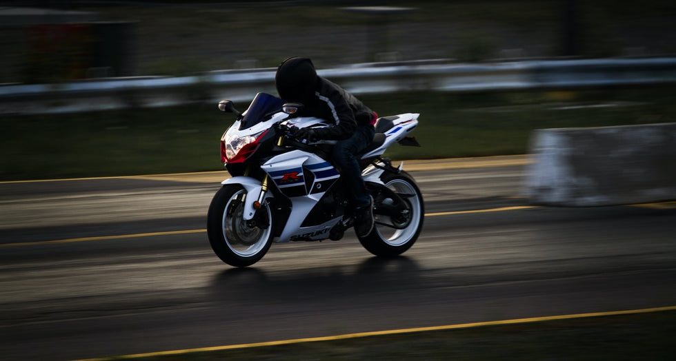 Motorbike Rider in Motion in the city with a black helmet