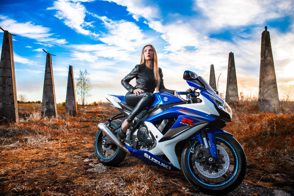 biker woman posing on motorbike with her motogear clothes